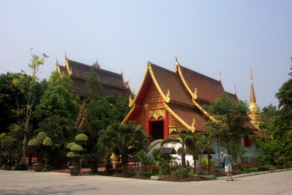 The ordination hall of Wat Phra Kaeo with the gilded pagoda behind